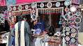 People purchasing traditional items from stalls setup during Ten-Days 'Folk Festival Lok Mela' at Lok Virsa