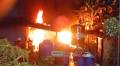 A house engulfed by fire, leaving three people dead
