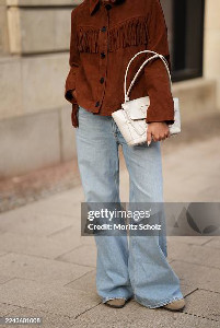 Laura Noltemeyer is seen wearing a brown suede leather jacket ...