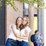 Identical twins graduate side by side with accounting degrees