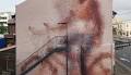 Fintan Magee puts a glass on his murals