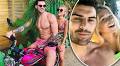 Love Island's Adam Collard puts on a cosy display with a blonde model whilst in Jamaica