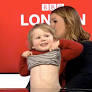 Cheeky toddler bares his tummy and leaves his siblings in fits of giggles live on the BBC News