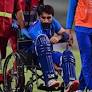 Rahmat leaves the field in a wheelchair after suffering calf injury