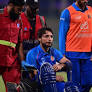 Afghanistan's Rahmat Shah tries to bat despite being injured, taken off the field in a wheelchair
