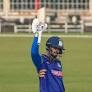 Sameer Rizvi raises his bat after reaching a half-century