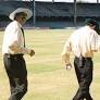 Umpires SK Tarapore and S Lakshmanan walk in before the start of the match