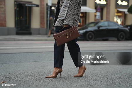 Füsun Lindner is seen wearing a light blue button-up shirt with a ...